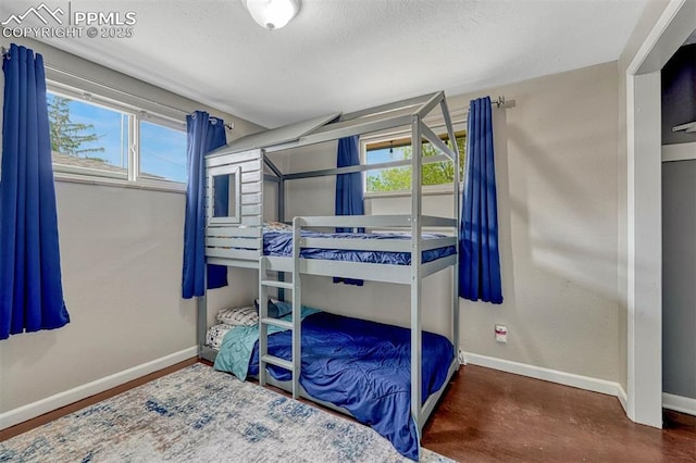 5477 E Asbury Ave, Denver, CO 80222 - bedroom with baseboards and a textured ceiling