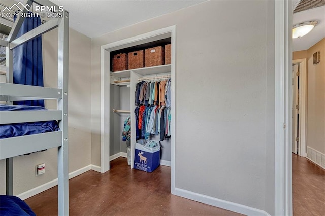 5477 E Asbury Ave, Denver, CO 80222 - bedroom featuring baseboards, finished concrete flooring, and a closet