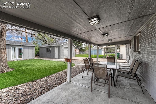 5477 E Asbury Ave, Denver, CO 80222 - view of patio featuring outdoor dining area and an outdoor structure