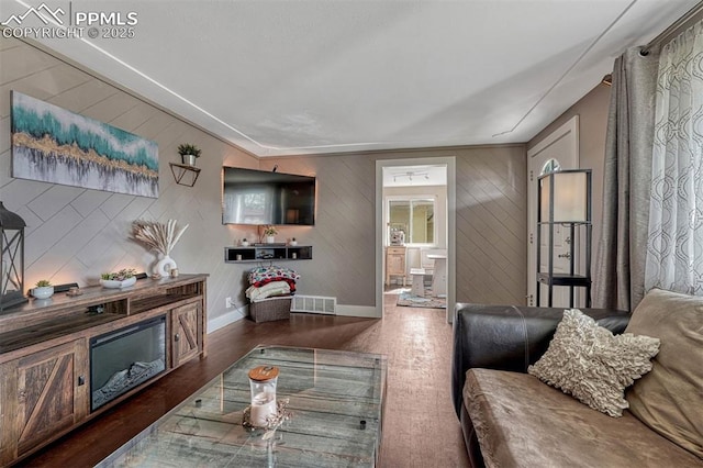 5477 E Asbury Ave, Denver, CO 80222 - living room with wood finished floors, baseboards, and wood walls