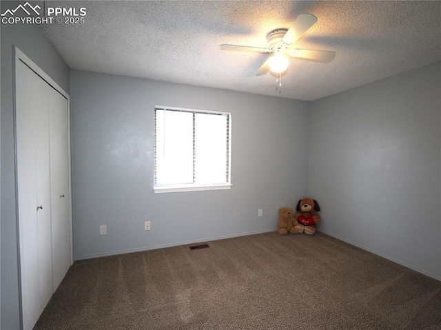 unfurnished bedroom featuring carpet, visible vents, a closet, and a textured ceiling