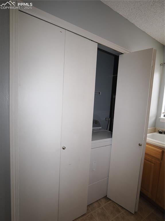 closet with washer / dryer and a sink