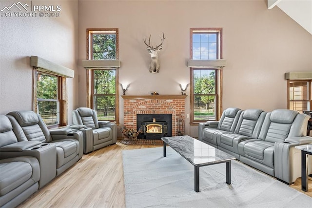 living area with light wood-style floors, high vaulted ceiling, and beam ceiling
