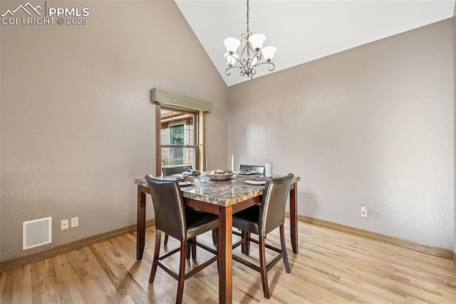 dining space featuring light wood-type flooring, baseboards, a chandelier, and visible vents