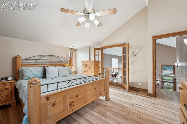 bedroom featuring high vaulted ceiling, ceiling fan, and light wood-style floors