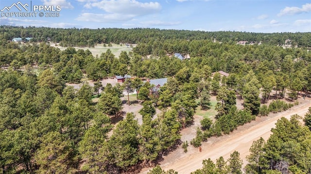 birds eye view of property with a view of trees