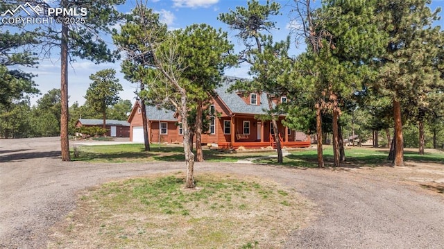 view of front of property with a porch and curved driveway