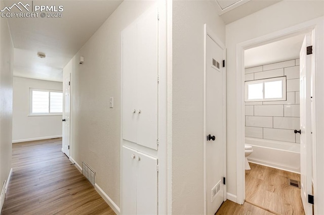 2222 Frontier Dr, Colorado Springs, CO 80911 - hallway with baseboards, visible vents, and light wood finished floors