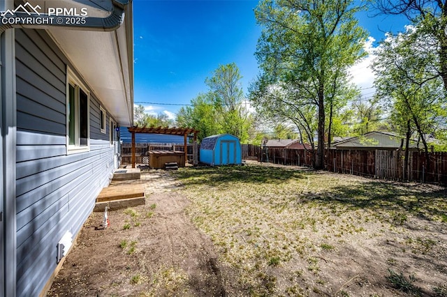 2222 Frontier Dr, Colorado Springs, CO 80911 - view of yard featuring a storage unit, a fenced backyard, and an outdoor structure