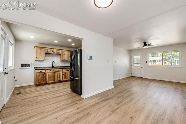 2222 Frontier Dr, Colorado Springs, CO 80911 - kitchen with light wood-style floors, baseboards, freestanding refrigerator, and open floor plan