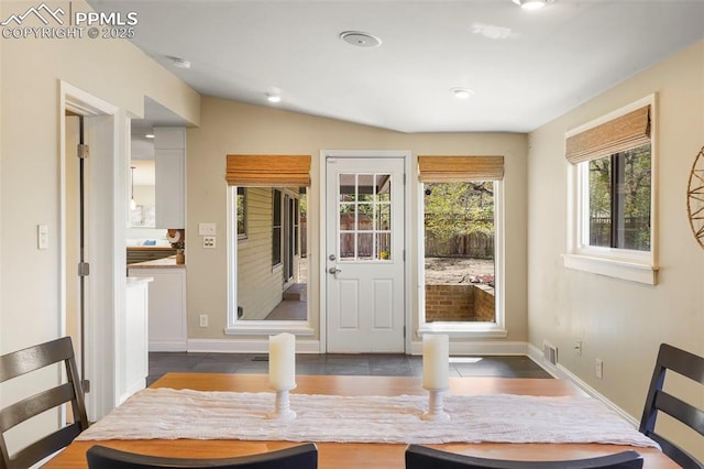 dining area featuring baseboards, visible vents, and dark wood finished floors