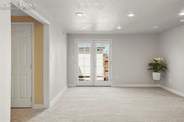 carpeted empty room featuring french doors, recessed lighting, baseboards, and visible vents