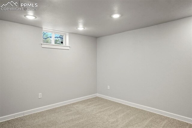 basement featuring carpet floors, baseboards, and recessed lighting