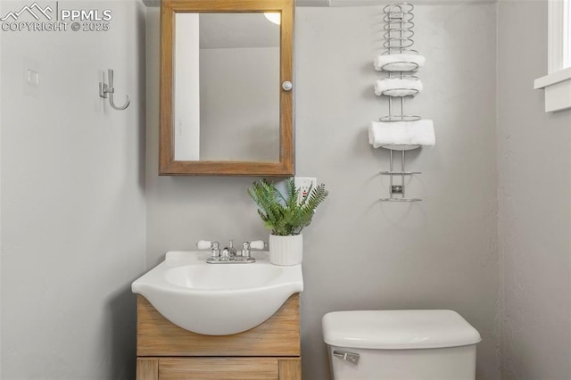 bathroom featuring vanity and toilet