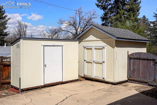 view of shed featuring fence