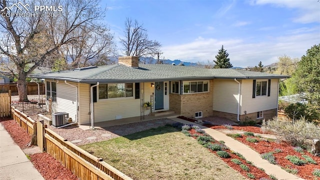 single story home with fence, central air condition unit, a chimney, and a front yard