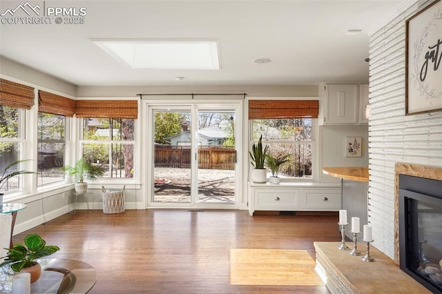 interior space featuring a skylight, wood finished floors, and a deck