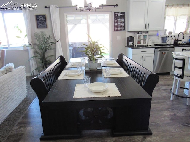 8766 Beaverhead Cir, Colorado Springs, CO 80908 - dining room featuring a chandelier, dark wood-style flooring, and baseboards