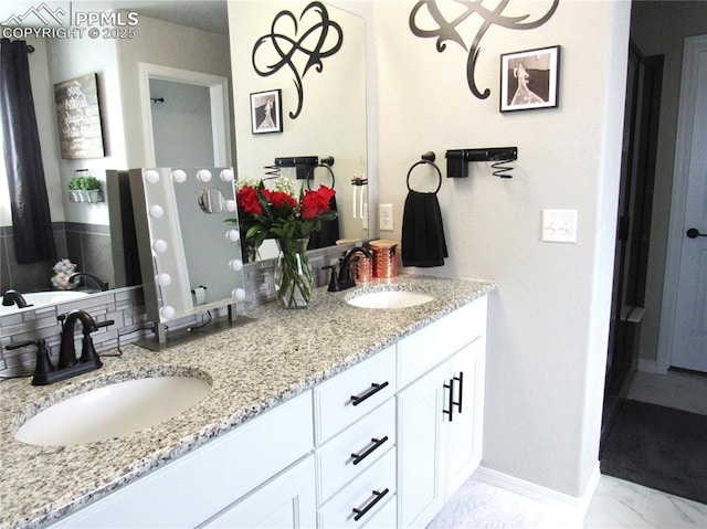 8766 Beaverhead Cir, Colorado Springs, CO 80908 - full bathroom featuring double vanity and baseboards