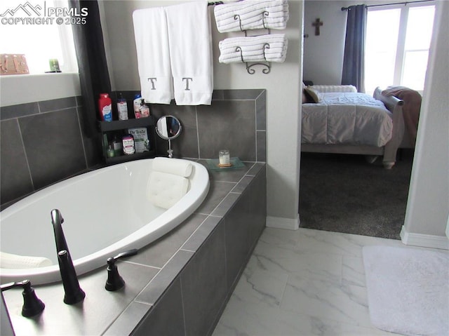 8766 Beaverhead Cir, Colorado Springs, CO 80908 - full bathroom featuring ensuite bathroom, healthy amount of natural light, marble finish floors, and a bath