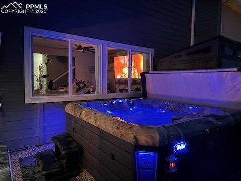 8766 Beaverhead Cir, Colorado Springs, CO 80908 - patio at twilight featuring a hot tub