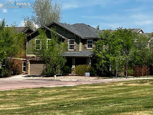 2790 Winterbourne St, Colorado Springs, CO 80910 - view of front of house with driveway and a garage