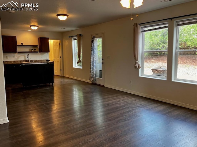 2790 Winterbourne St, Colorado Springs, CO 80910 - kitchen featuring dark wood-type flooring, open shelves, baseboards, open floor plan, and dark brown cabinetry