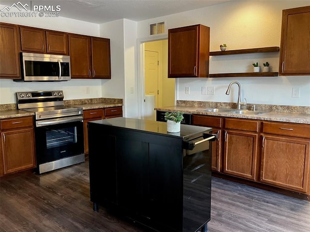 2790 Winterbourne St, Colorado Springs, CO 80910 - kitchen featuring appliances with stainless steel finishes, a sink, dark wood-type flooring, open shelves, and a center island