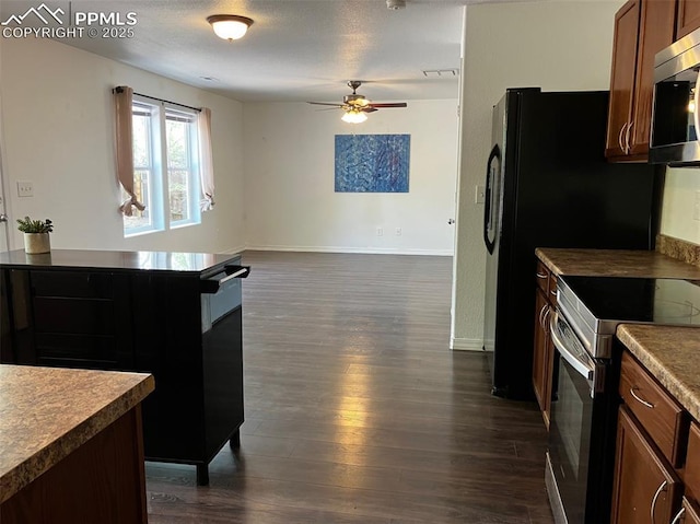 2790 Winterbourne St, Colorado Springs, CO 80910 - kitchen featuring stainless steel appliances, a ceiling fan, dark wood-type flooring, baseboards, and open floor plan