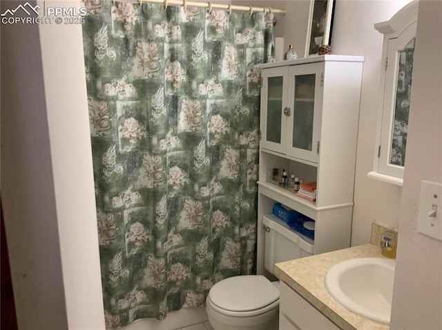 6905 Chippewa Rd, Colorado Springs, CO 80915 - full bathroom featuring vanity, toilet, a shower with shower curtain, and tile patterned floors