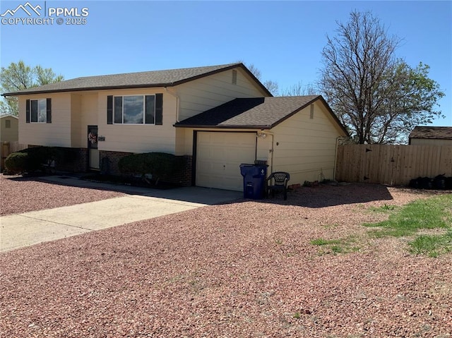 6905 Chippewa Rd, Colorado Springs, CO 80915 - view of front of house with concrete driveway, a garage, brick siding, and roof with shingles
