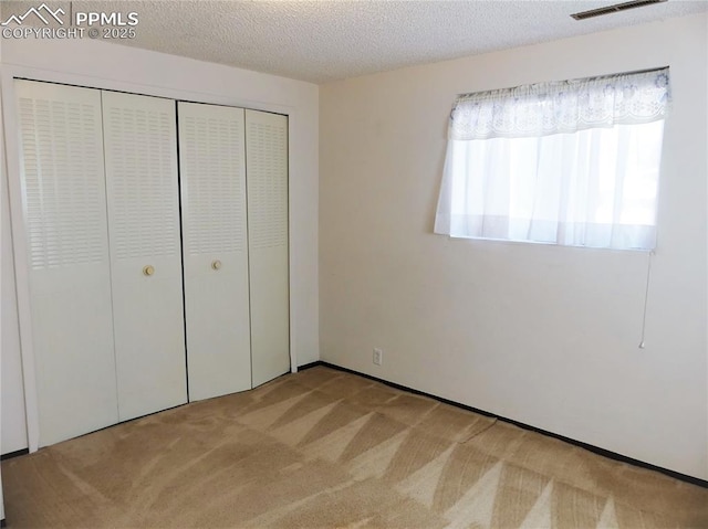 6905 Chippewa Rd, Colorado Springs, CO 80915 - unfurnished bedroom featuring carpet floors, a closet, and a textured ceiling