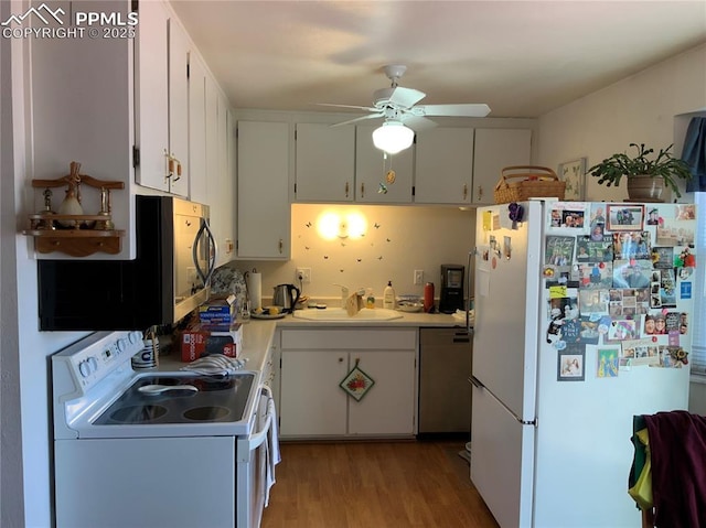 6905 Chippewa Rd, Colorado Springs, CO 80915 - kitchen featuring white appliances, a sink, a ceiling fan, light wood-style flooring, and light countertops