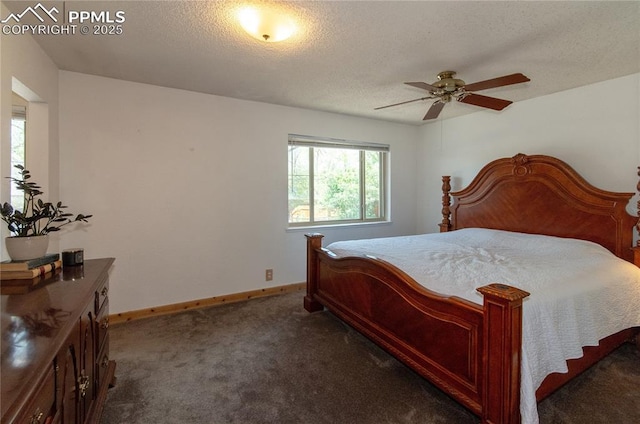 bedroom featuring dark colored carpet, a textured ceiling, and baseboards