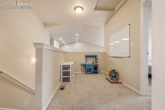 hallway featuring carpet floors, visible vents, baseboards, recessed lighting, and an upstairs landing