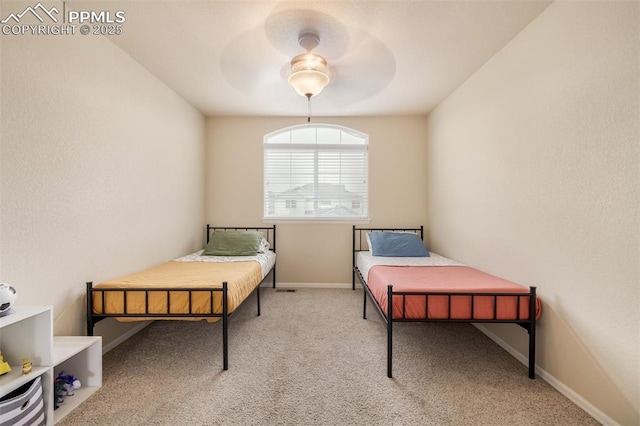 carpeted bedroom with baseboards and ceiling fan