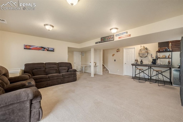 living room with baseboards, carpet, stairs, and visible vents
