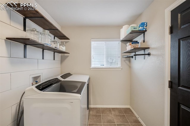 clothes washing area featuring laundry area, washer and clothes dryer, baseboards, and tile patterned flooring