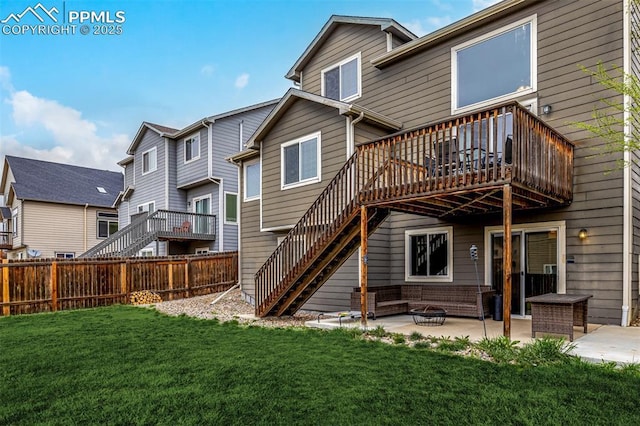 rear view of house featuring a wooden deck, a fenced backyard, a patio area, a yard, and stairway