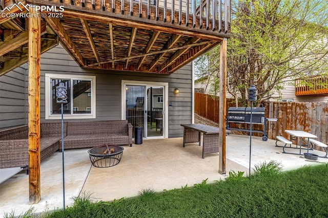 view of patio / terrace with fence and an outdoor fire pit