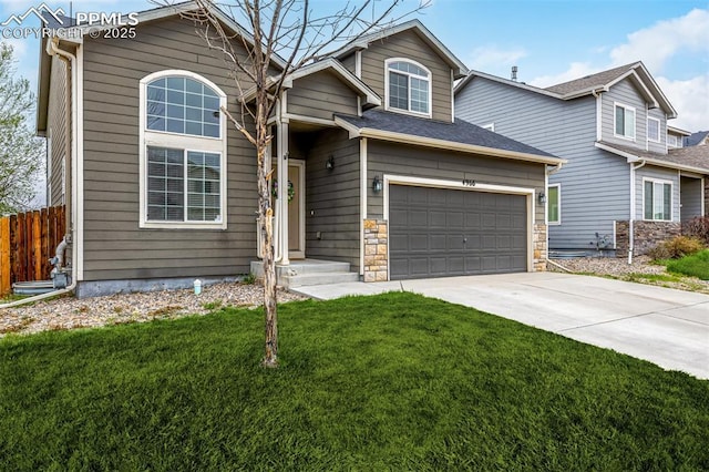 view of front facade with concrete driveway, fence, a front yard, and a garage