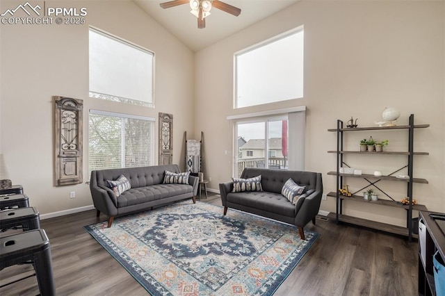 living room featuring baseboards, a ceiling fan, high vaulted ceiling, and wood finished floors