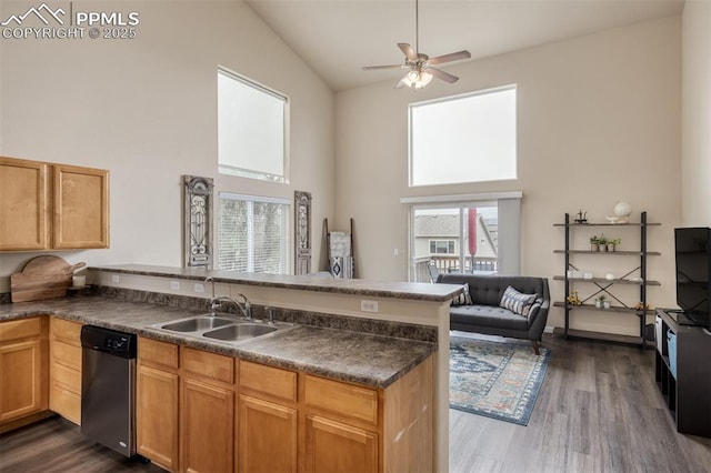 kitchen with a peninsula, high vaulted ceiling, plenty of natural light, and dishwasher