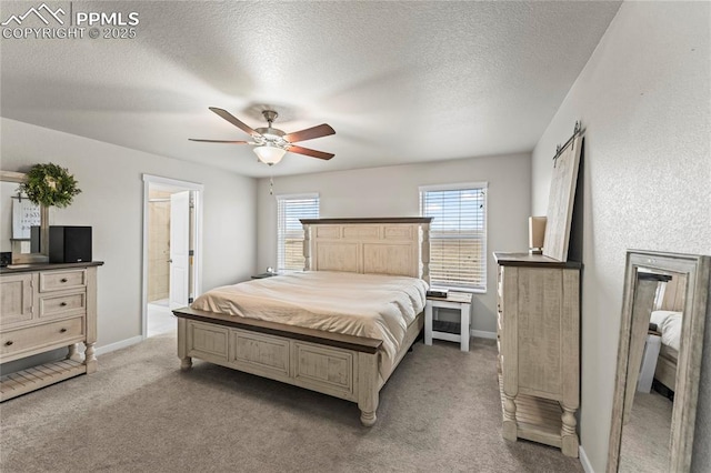 bedroom featuring baseboards, light carpet, and a textured ceiling