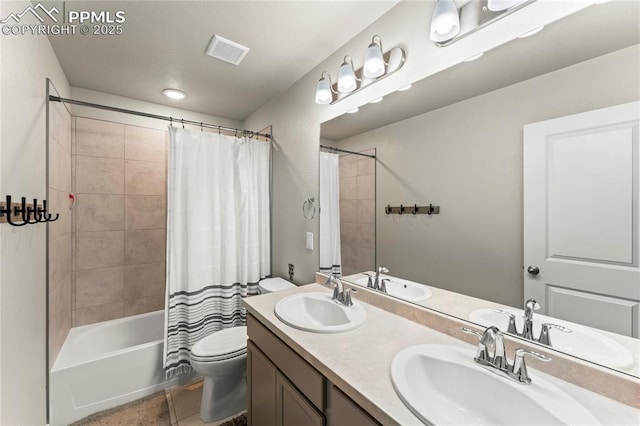 bathroom featuring visible vents, a sink, shower / bath combination with curtain, and toilet