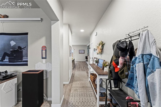 hall featuring baseboards and wood finished floors