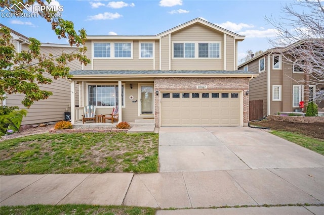 view of front of property featuring a porch, an attached garage, driveway, and brick siding