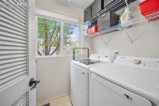 laundry area featuring baseboards, laundry area, and washing machine and clothes dryer