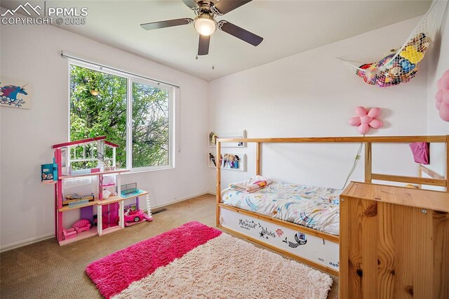 bedroom with baseboards, ceiling fan, carpet flooring, and visible vents