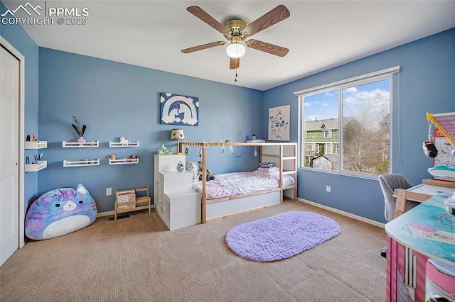 carpeted bedroom featuring baseboards and a ceiling fan
